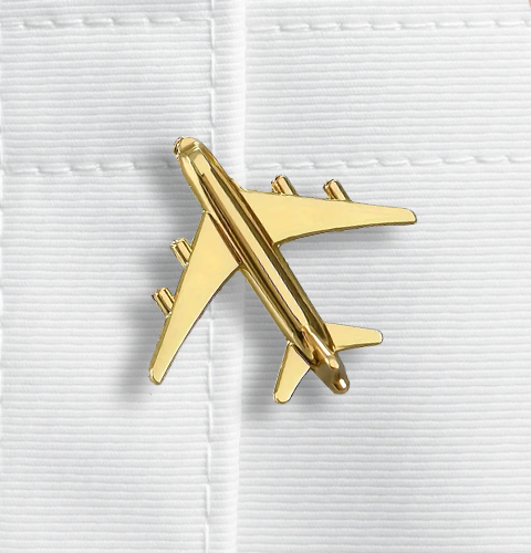 Gold airplane-shaped object on a white background