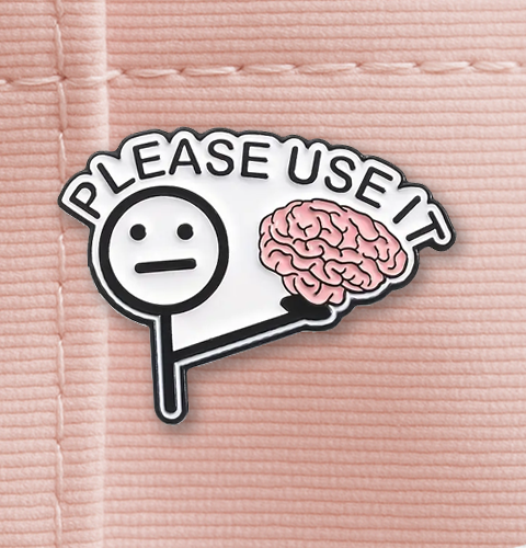 Pin with a brain and speech bubble saying 'Please use it' on a pink background
