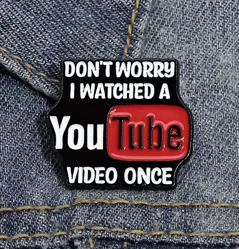 Enamel pin with 'Don't worry, I watched a YouTube video once' text on denim background