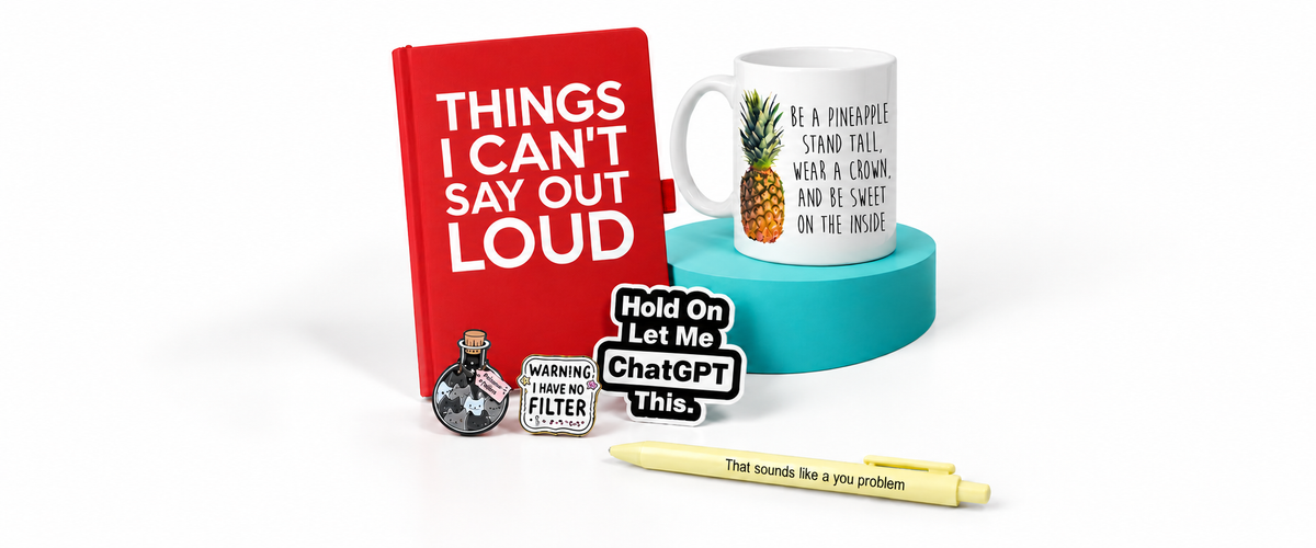 Red notebook, pineapple mug, enamel pins, ChatGPT sticker and yellow pen